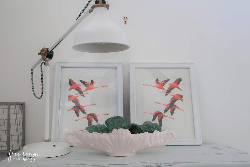 Flamingo prints in white frames and white lamp