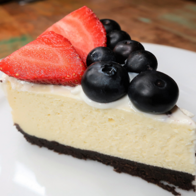 slice of cheesecake with blueberries and strawberries topping