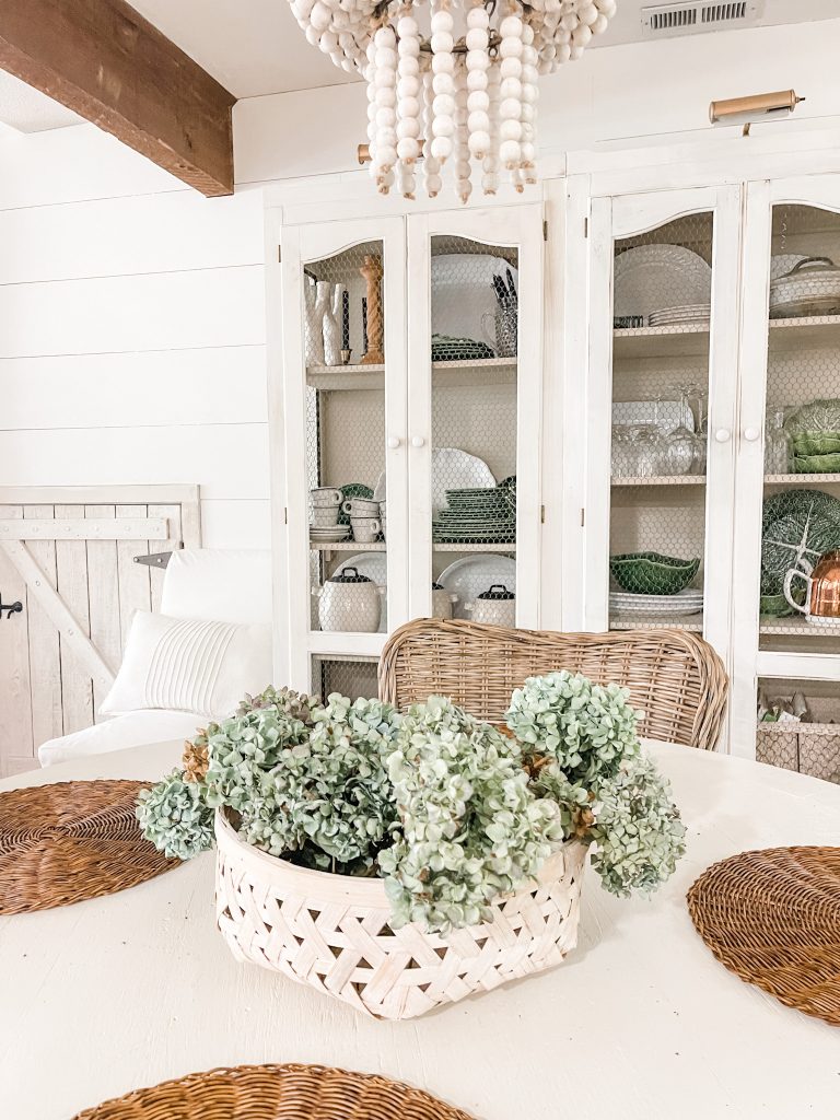 Dining room table with hydrangeas in a white basket