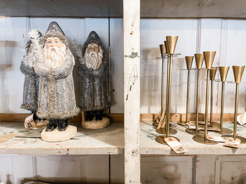 Carved wooden Santas and Brass candlesticks