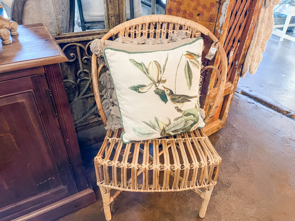 Wicker chair with pillow on it