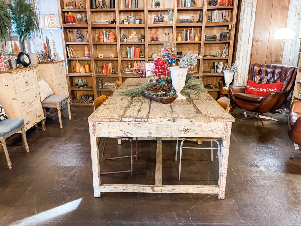 Vintage store with bookshelves and chippy white table