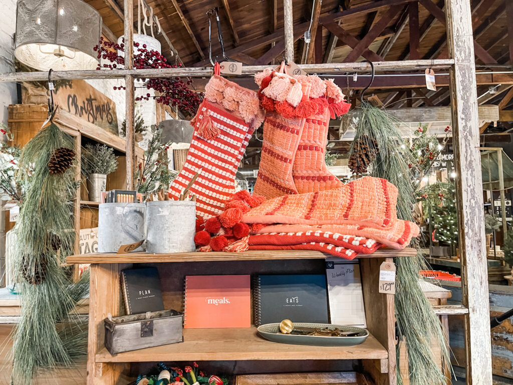 pink and red Christmas stockings with pom pom trim