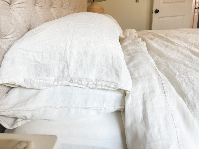 white fluffy pillows stacked on cozy bed