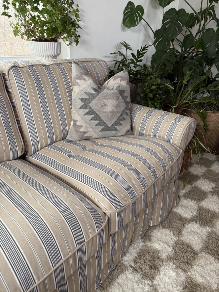 IKEA Uppland sofa accessorized with wool pillow in subtle neutrals