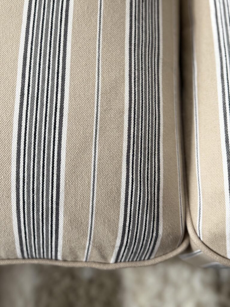 Close up of IKEA Uppland Karlshov gray beige slipcover, Gray and beige stripes of several different widths.