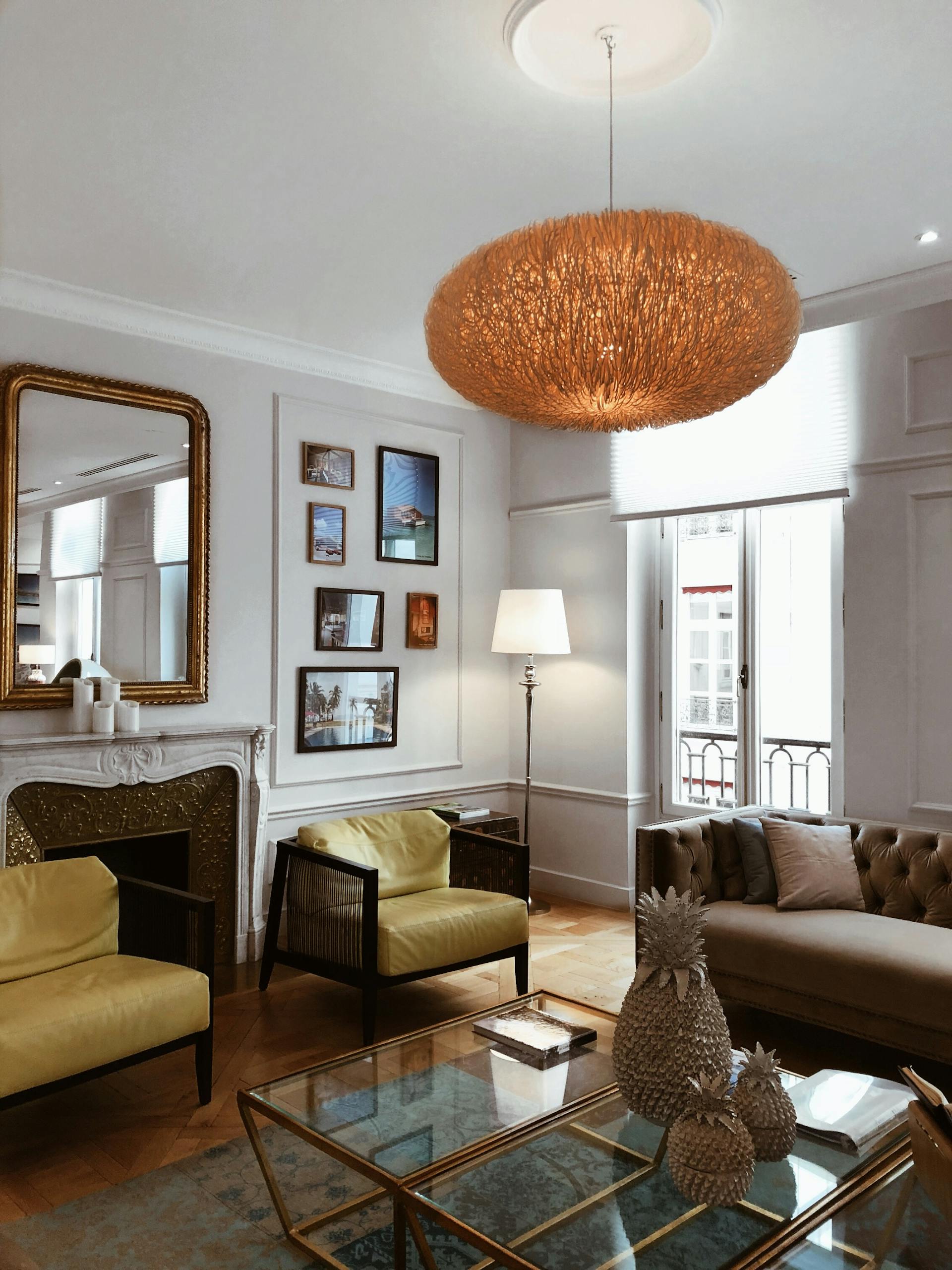 Chic living room in Paris featuring stylish furniture, elegant chandelier, and modern decor.