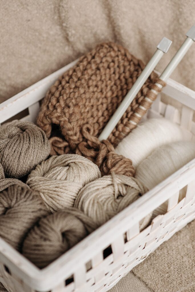 Knitting yarn stored in a white basket